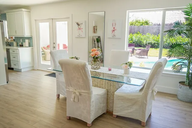a dining room with furniture window and wooden floor