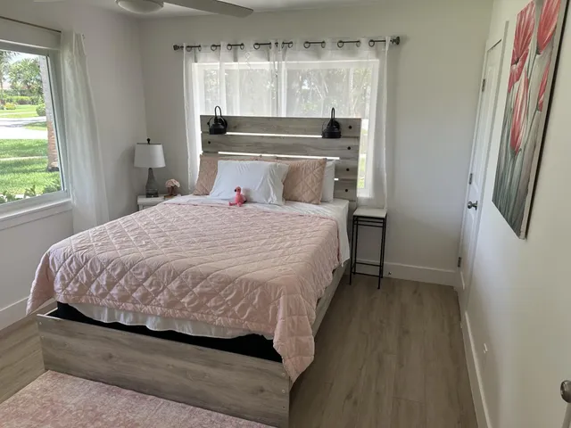 a bedroom with a bed and a window