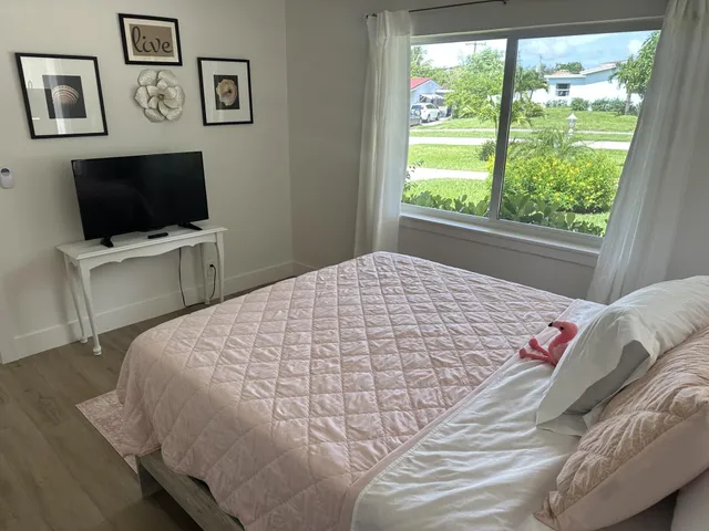 a bedroom with a bed and a flat screen tv