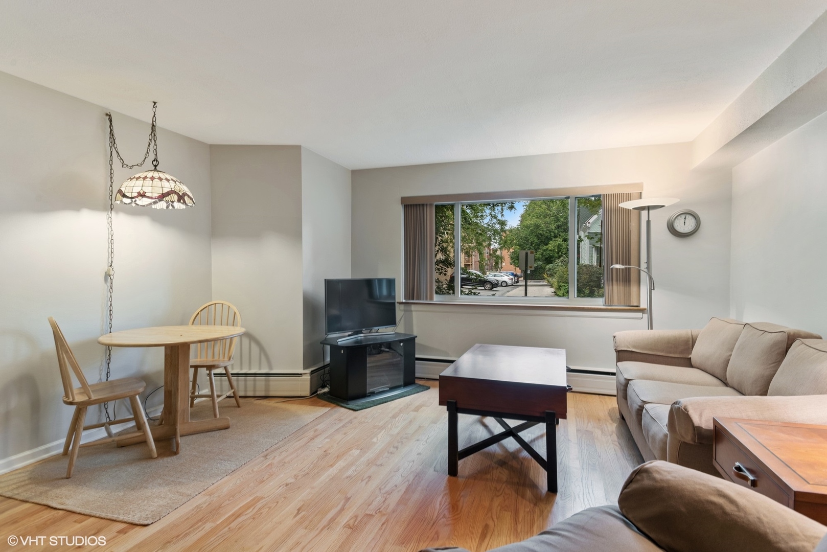 737 Ridge Avenue, Unit 1L Evanston, IL 60202 - Photo 2 of 14 a living room with furniture a window and a flat screen tv