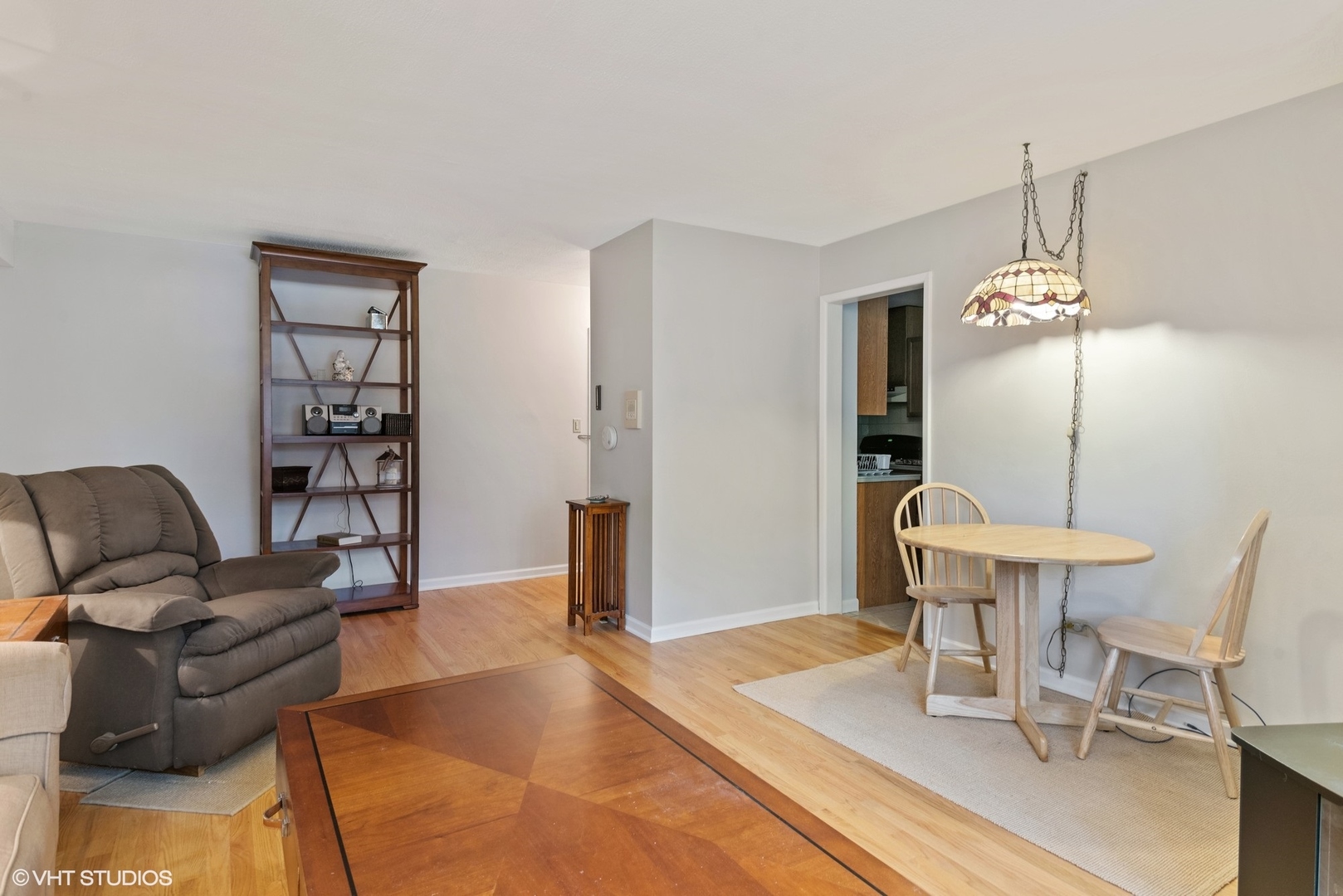737 Ridge Avenue, Unit 1L Evanston, IL 60202 - Photo 3 of 14 a living room with furniture a dining table and a chandelier