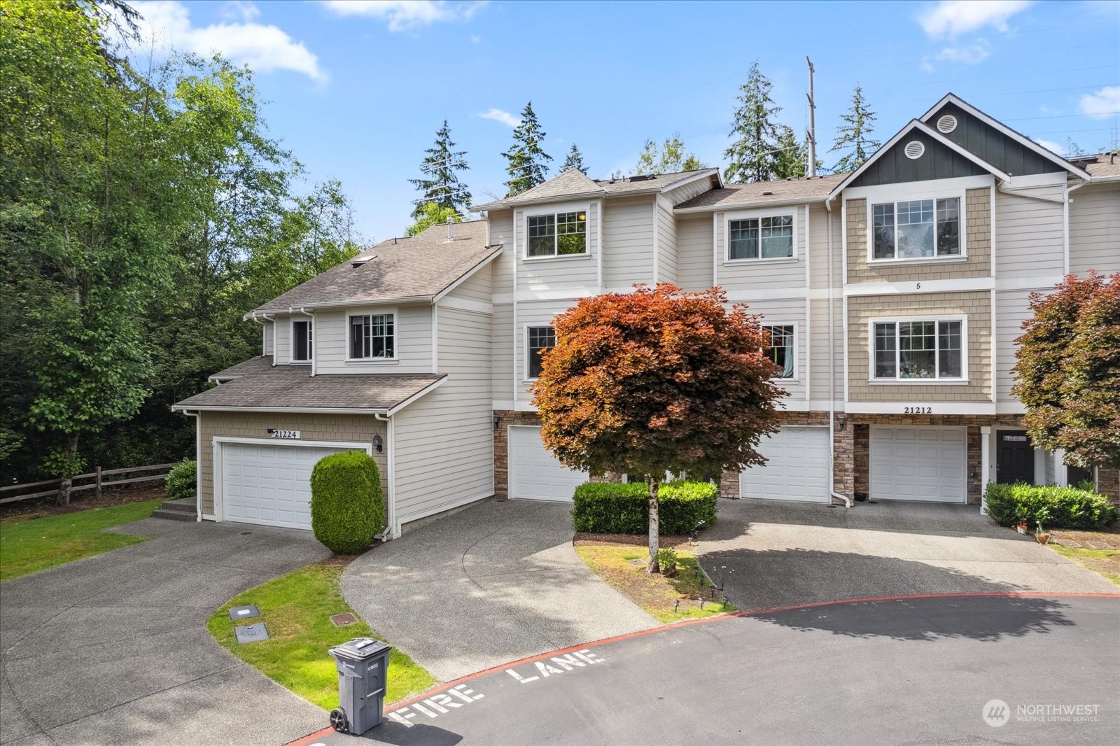 21220 11th Drive Southeast Bothell, WA 98021 - Photo 3 of 37 a front view of a house with a garden and trees