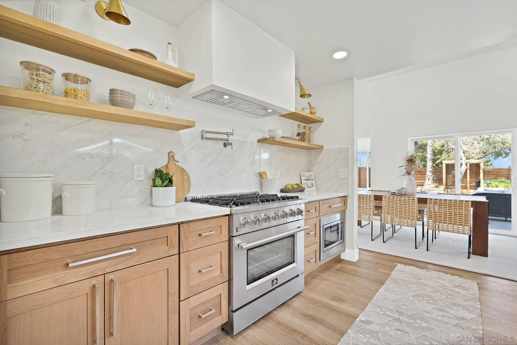 7815 Quebrada Circle Carlsbad, CA 92009 - Photo 11 of 32 a kitchen with white cabinets and wooden floor