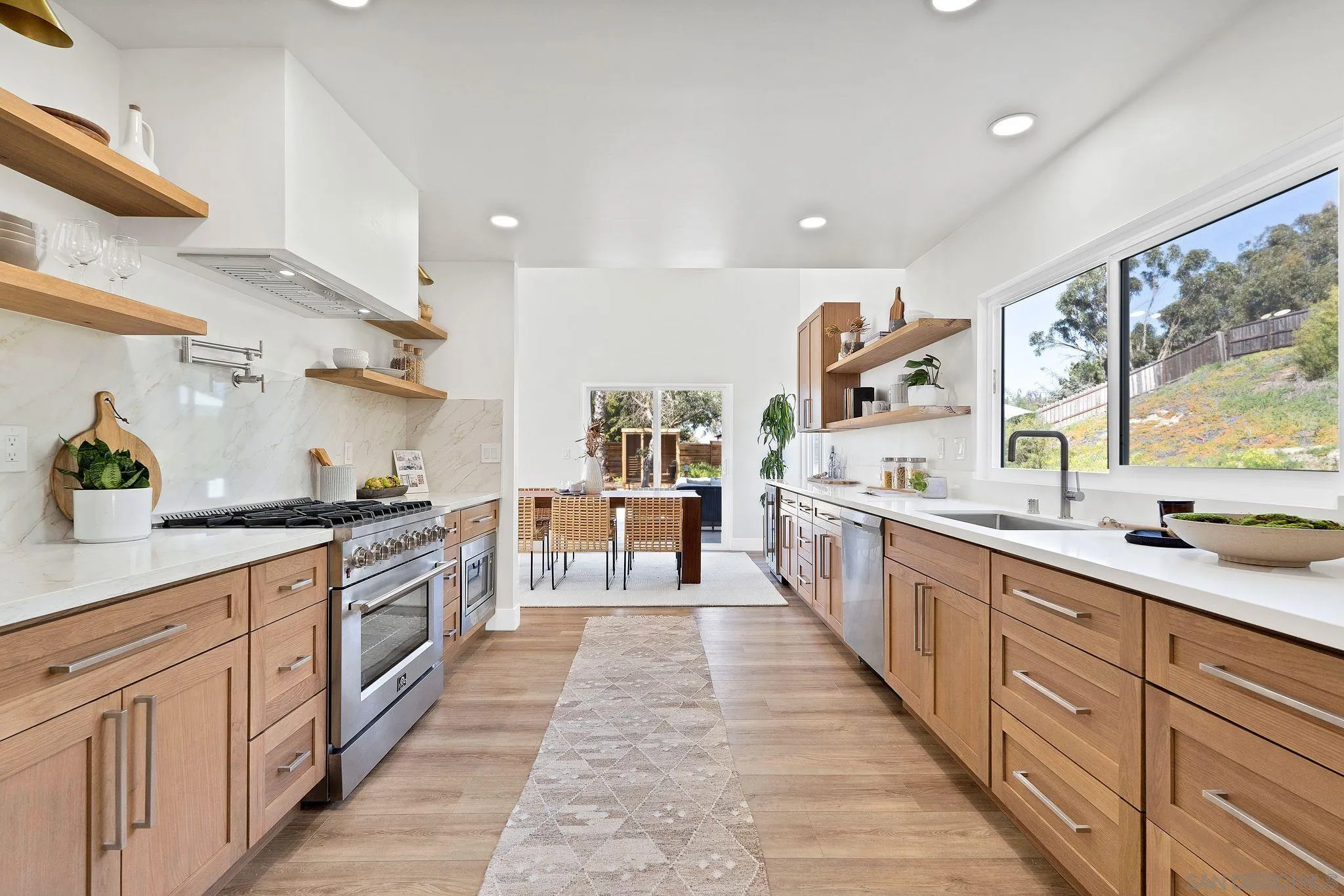 7815 Quebrada Circle Carlsbad, CA 92009 - Photo 12 of 32 a large kitchen with stainless steel appliances lots of counter space and a sink