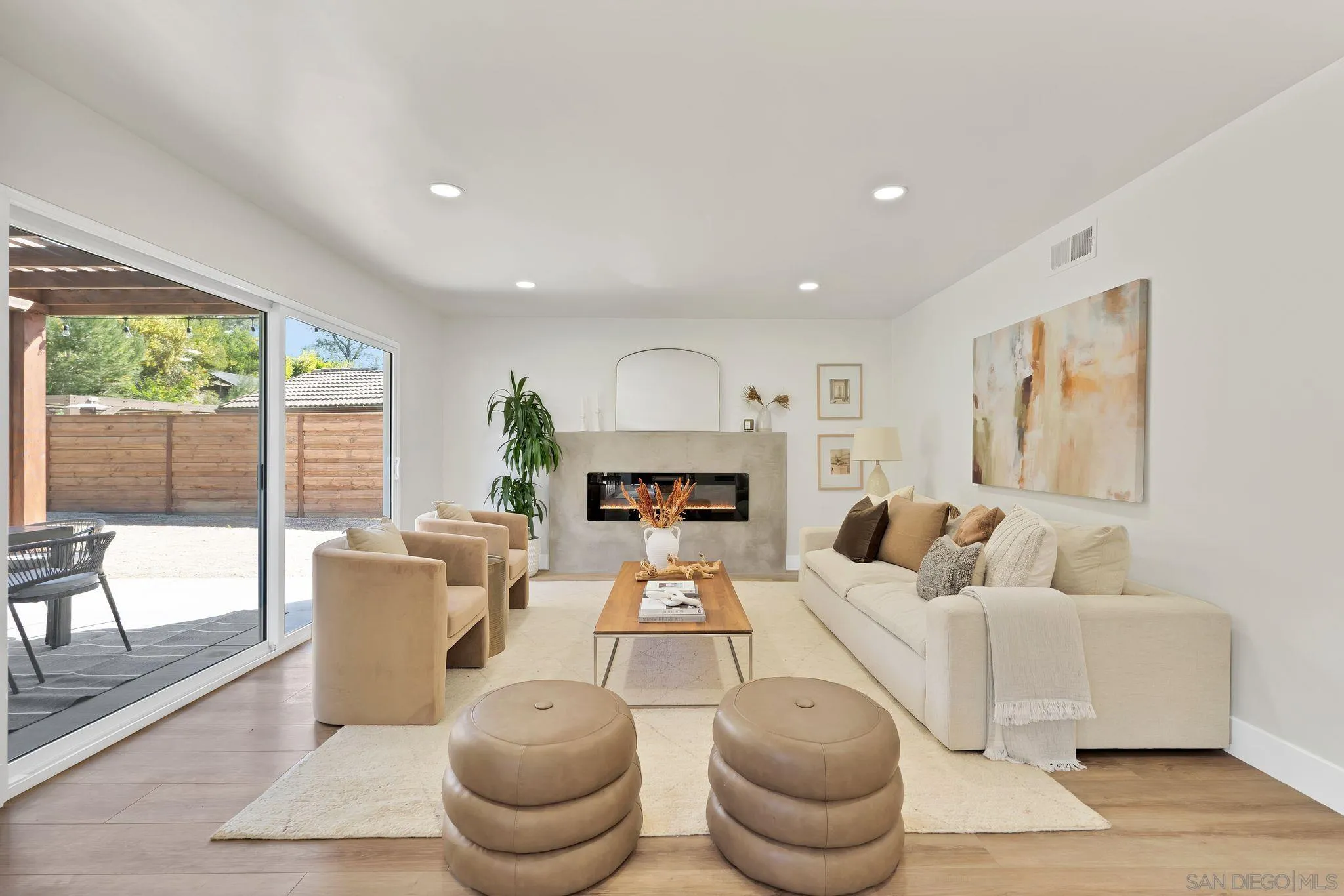 7815 Quebrada Circle Carlsbad, CA 92009 - Photo 15 of 32 a living room with furniture a large window and a fireplace