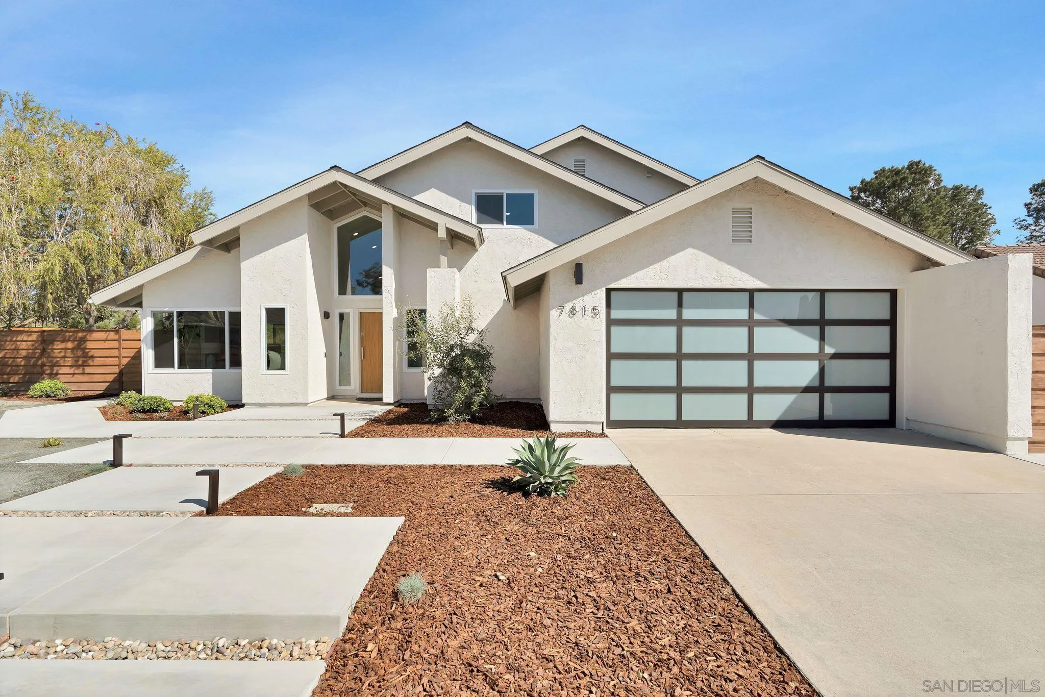 7815 Quebrada Circle Carlsbad, CA 92009 - Photo 2 of 32 a front view of a house with a yard and garage