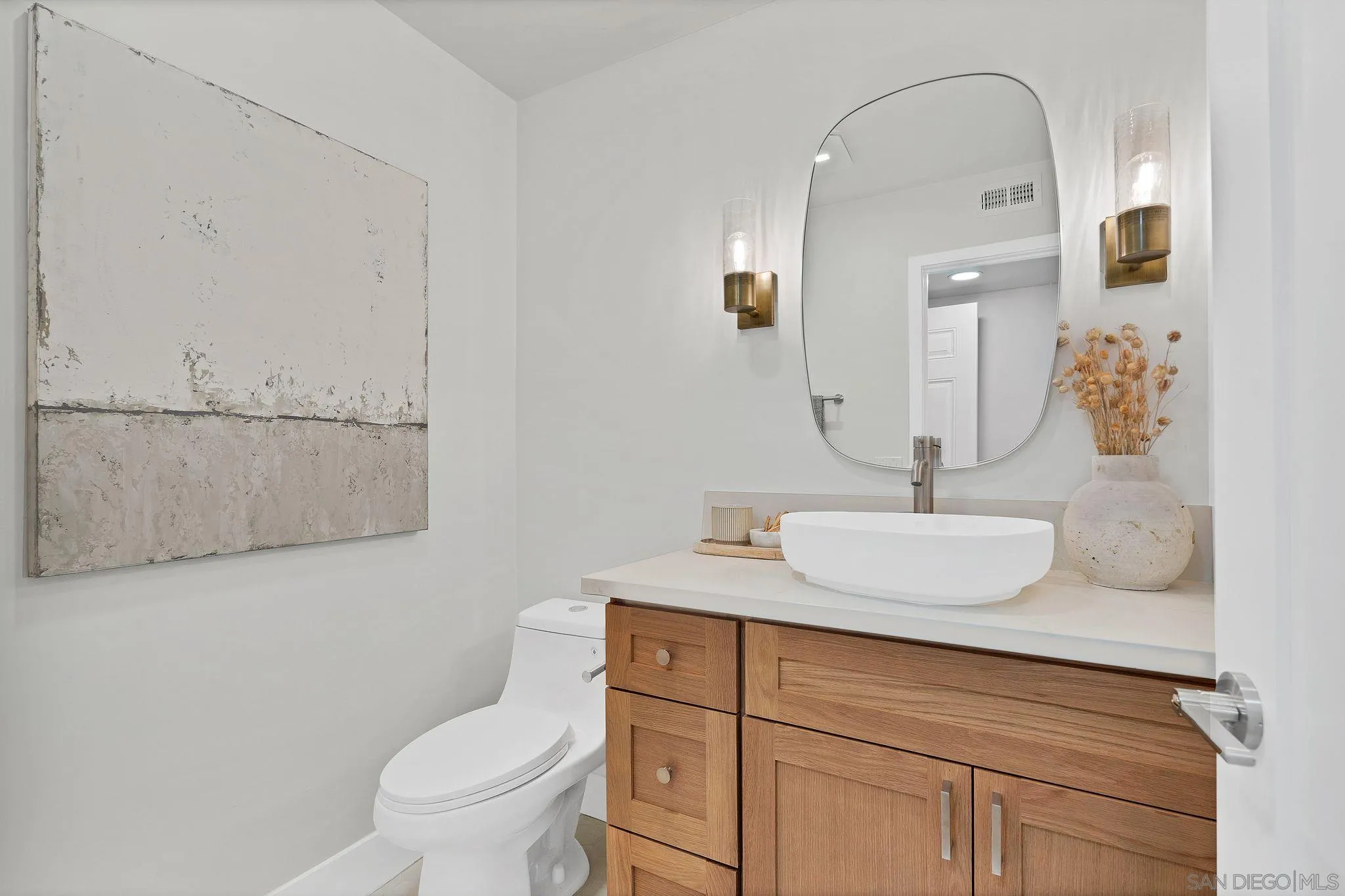 7815 Quebrada Circle Carlsbad, CA 92009 - Photo 23 of 32 a bathroom with a toilet sink and mirror