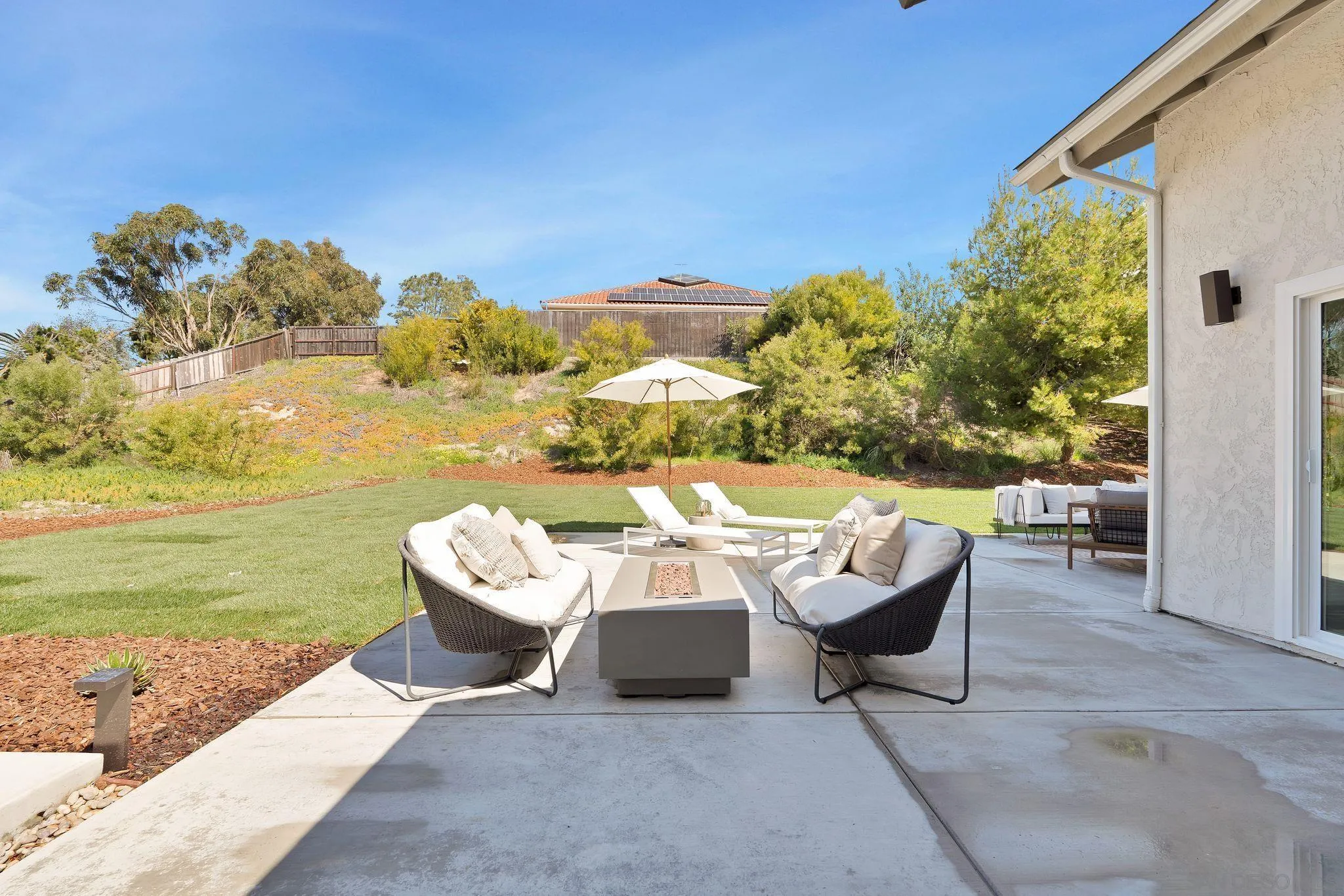 7815 Quebrada Circle Carlsbad, CA 92009 - Photo 28 of 32 a view of a patio with lawn chairs and a couple of flower plants