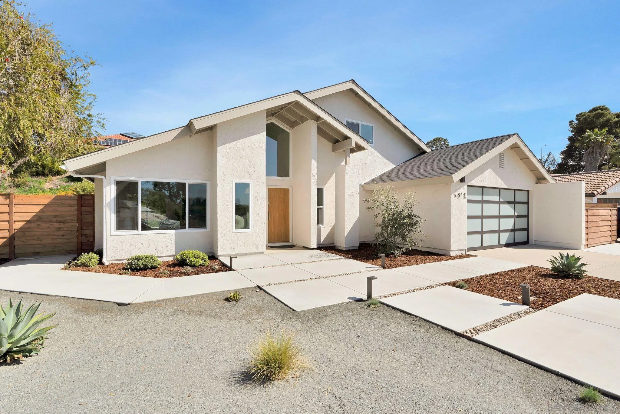 7815 Quebrada Circle Carlsbad, CA 92009 - Photo 3 of 32 a front view of a house with a garden