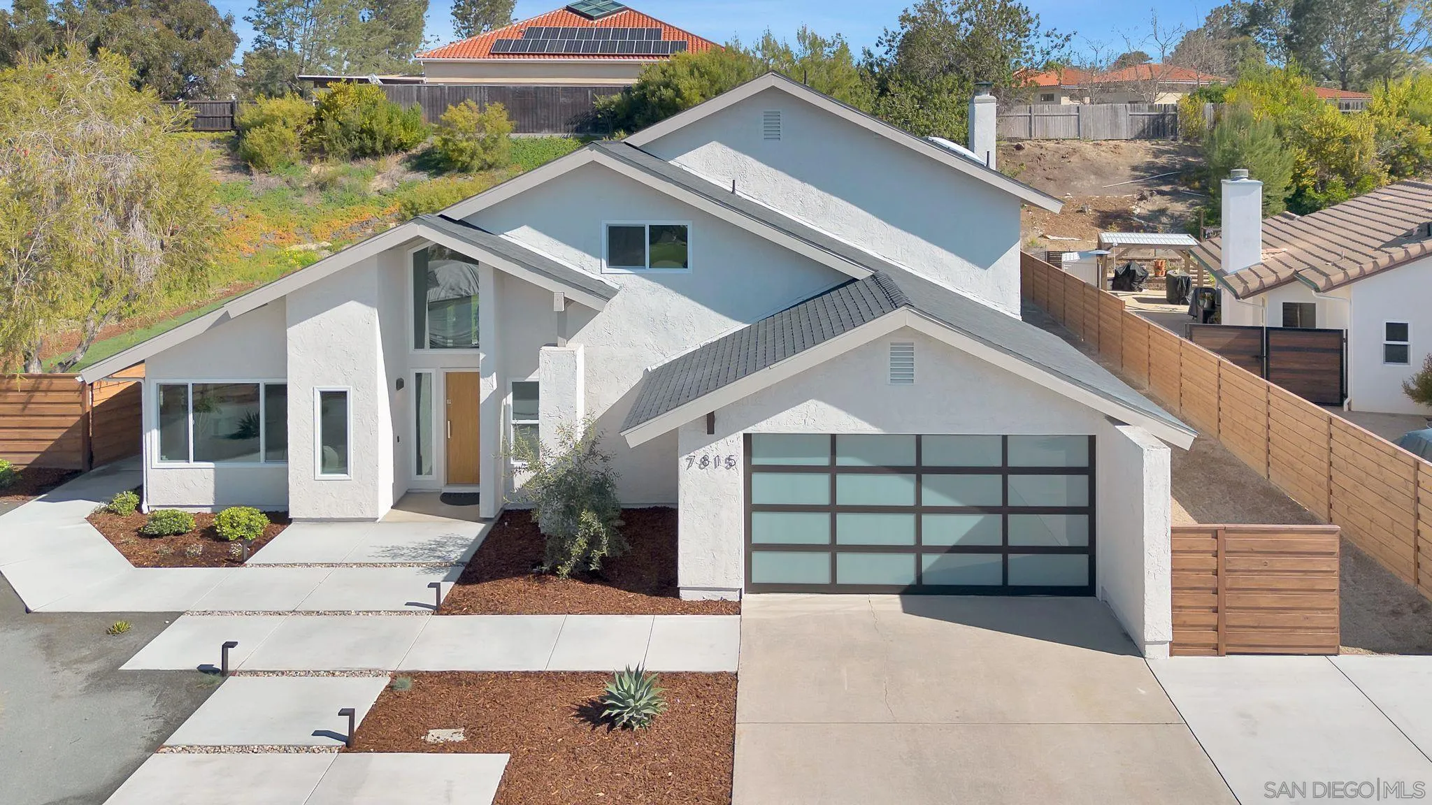 7815 Quebrada Circle Carlsbad, CA 92009 - Photo 4 of 32 a front view of a house with a yard