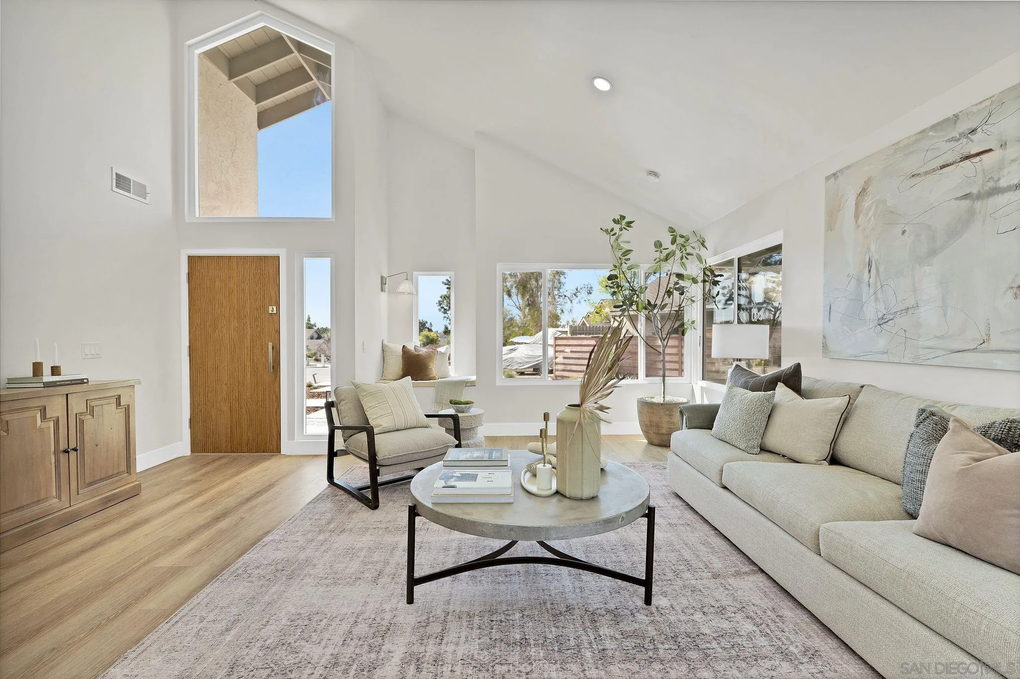 7815 Quebrada Circle Carlsbad, CA 92009 - Photo 7 of 32 a living room with furniture and a chandelier