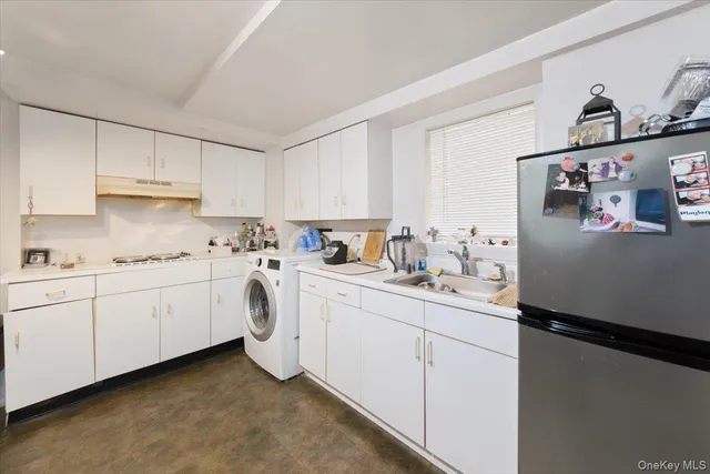 a kitchen with cabinets appliances and a counter top