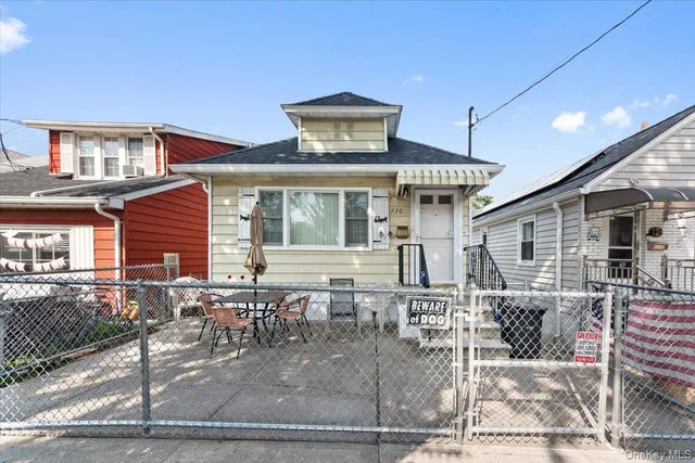 a front view of a house with large windows