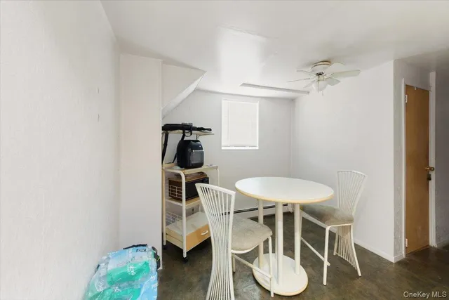 a dining room with furniture and a window