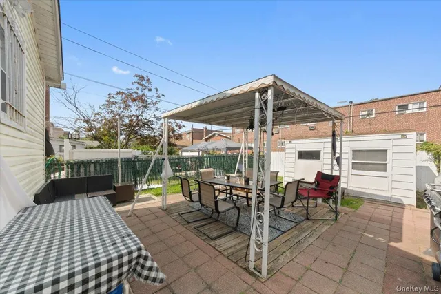 a view of a roof deck with table and chairs under an umbrella