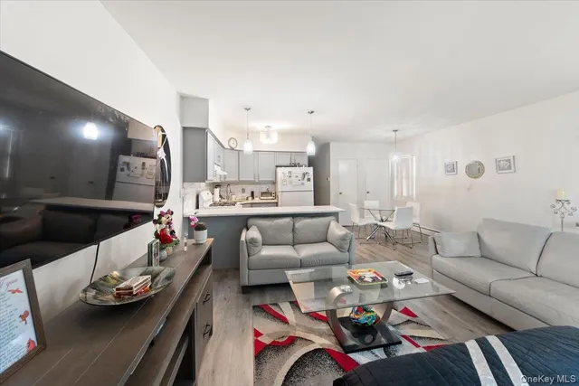 a living room with furniture kitchen and a table