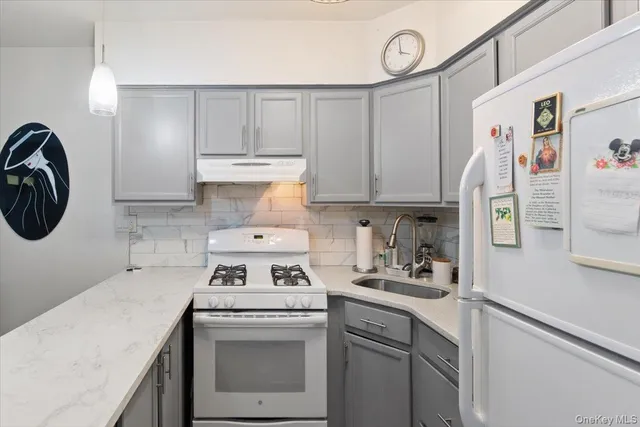 a kitchen with a stove cabinets and a refrigerator