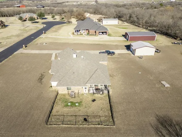 an aerial view of residential houses with outdoor space