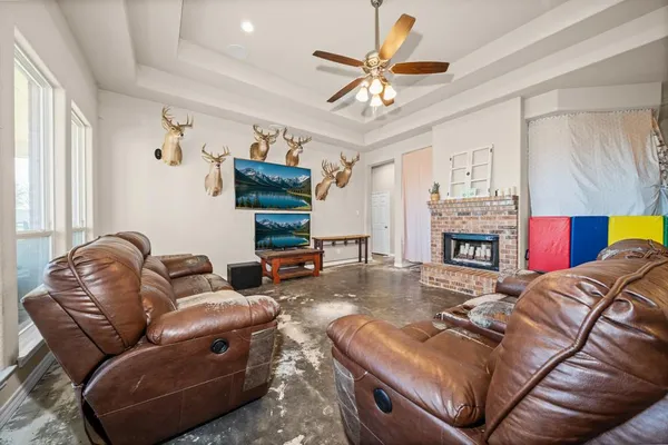 a living room with furniture and a chandelier