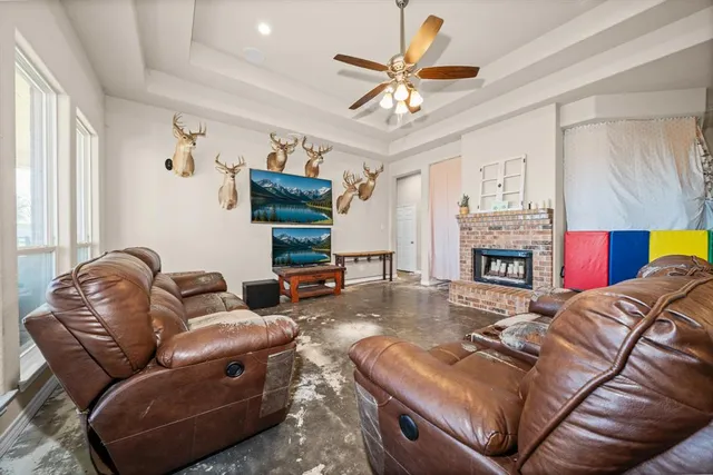 a living room with furniture and a chandelier