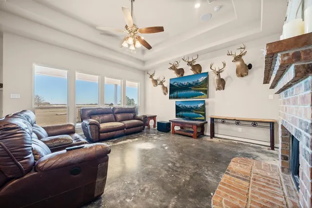 a living room with furniture and a ceiling fan