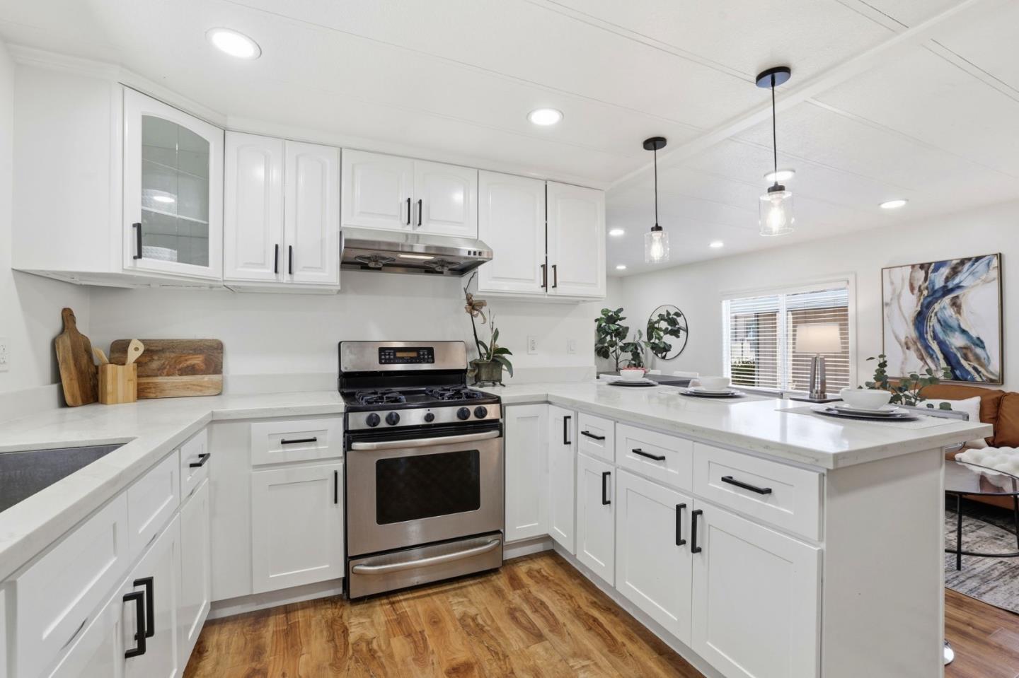 555 Umbarger Road, Unit 31 San Jose, CA 95111 - Photo 6 of 18 a kitchen with kitchen island a stove a sink and wooden floor