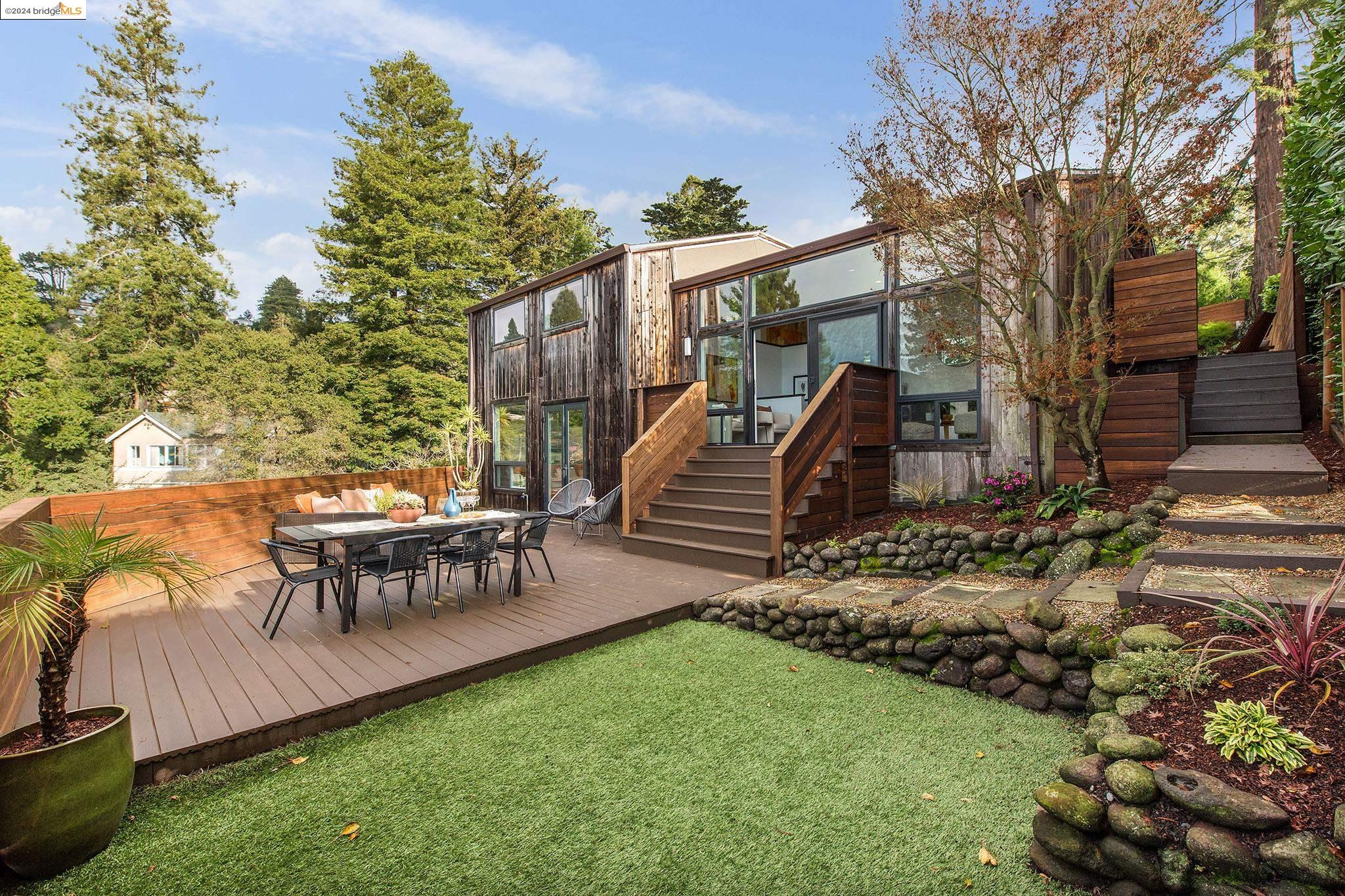 a view of a house with backyard and sitting area