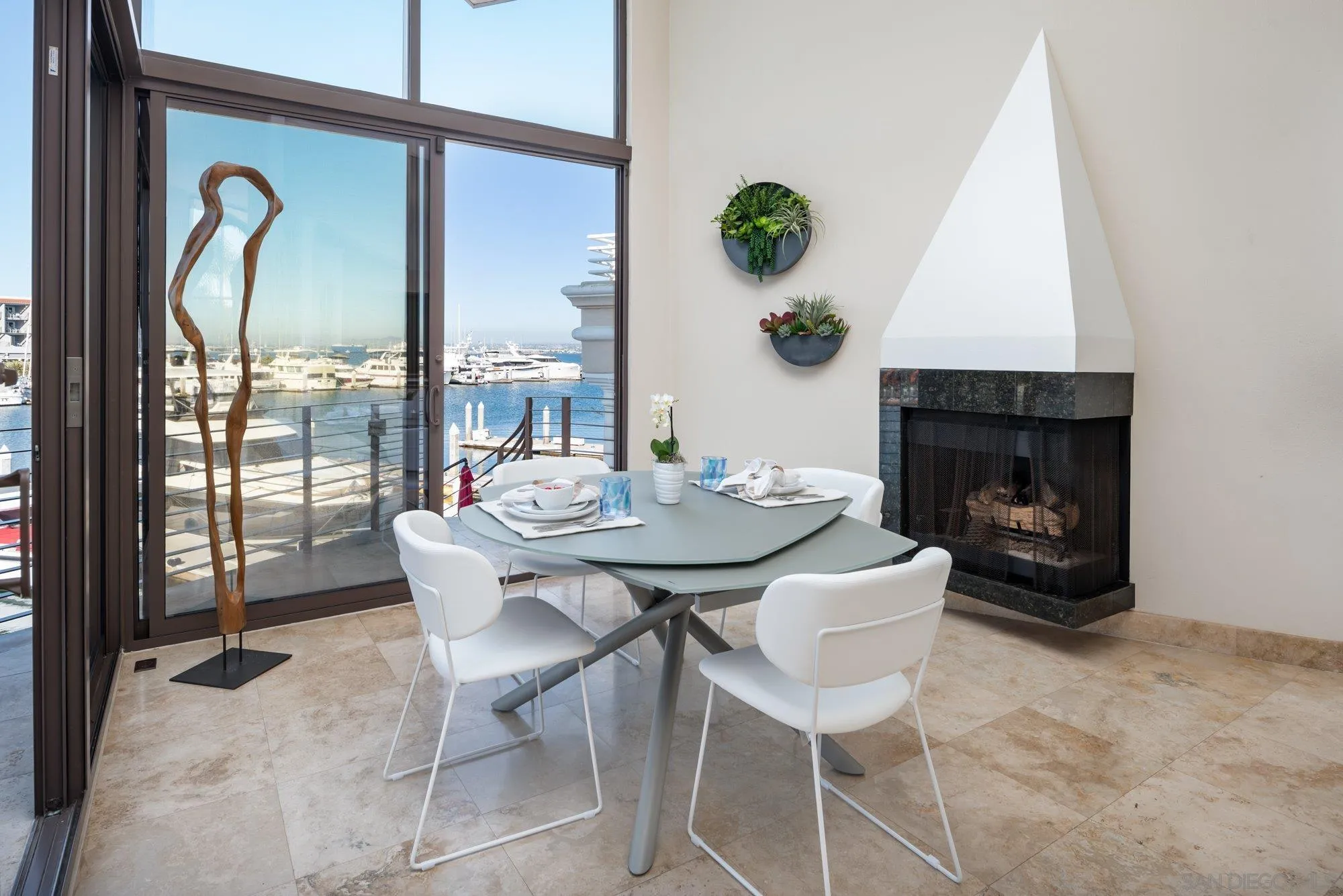 25 The Point Coronado, CA 92118 - Photo 13 of 52 a dining room with furniture and a fireplace