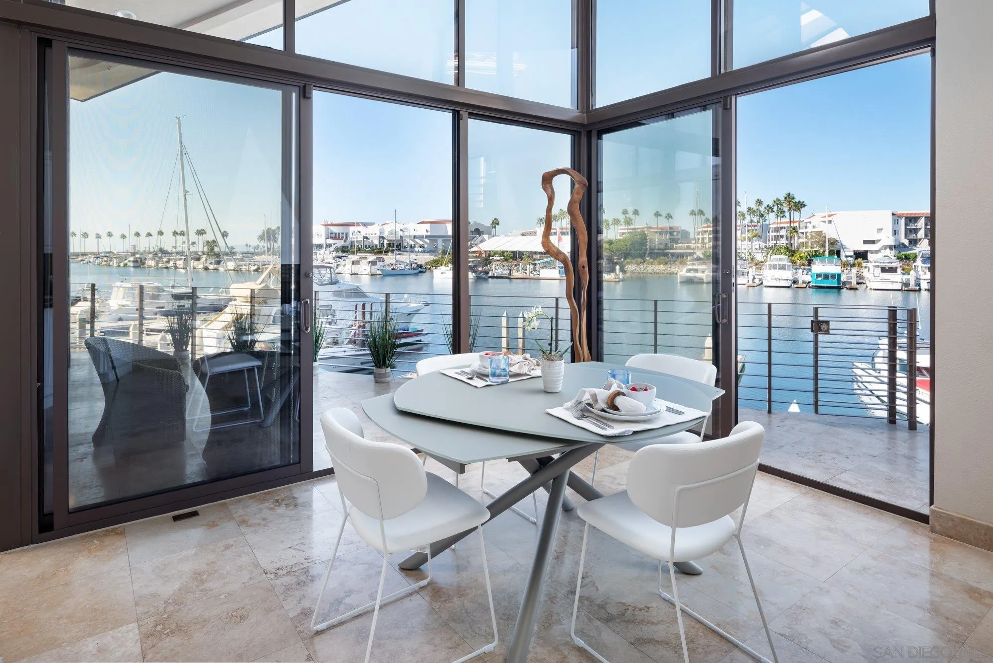 25 The Point Coronado, CA 92118 - Photo 14 of 52 a dining room with furniture and a floor to ceiling window
