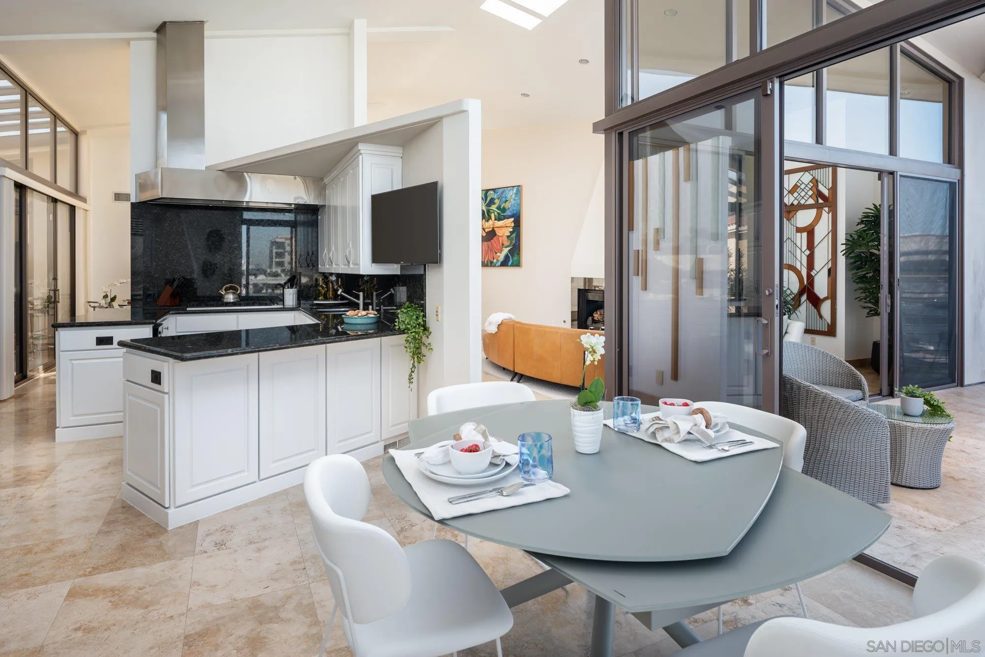 25 The Point Coronado, CA 92118 - Photo 19 of 52 a dining room with furniture a large window and a kitchen view