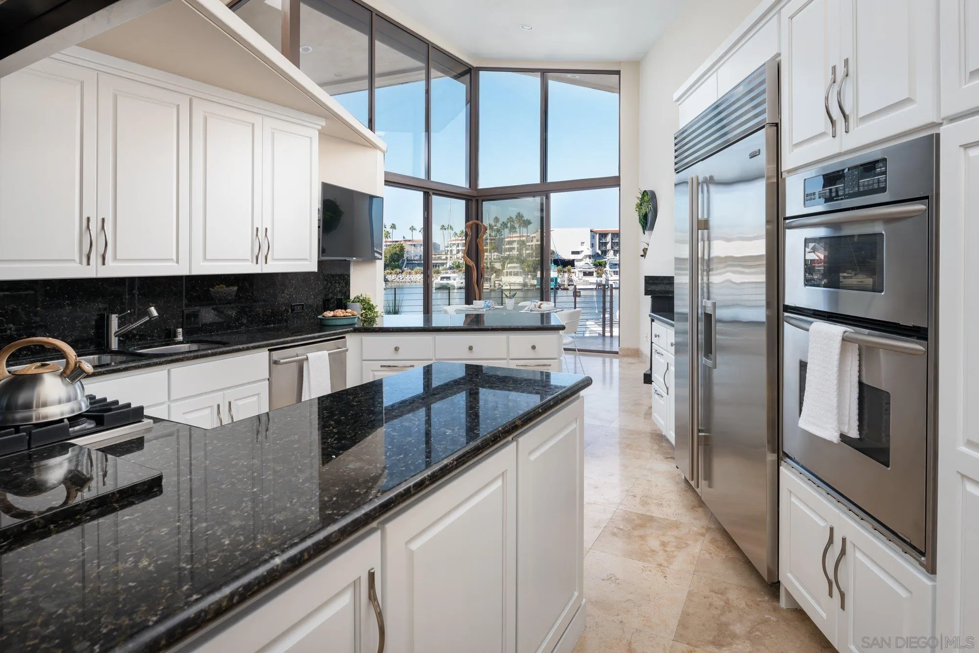25 The Point Coronado, CA 92118 - Photo 20 of 52 a kitchen with stainless steel appliances granite countertop a sink a stove and a refrigerator