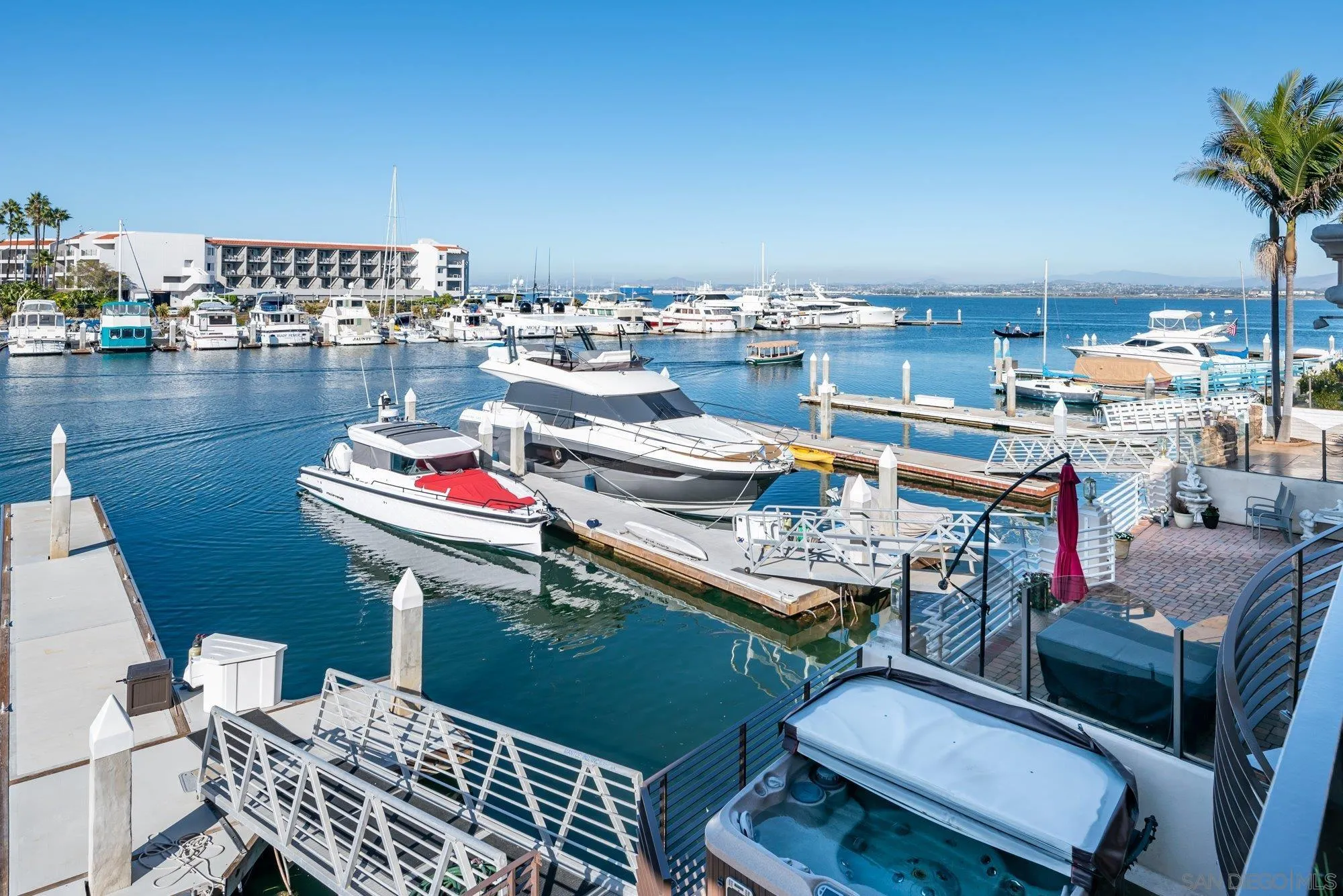 25 The Point Coronado, CA 92118 - Photo 21 of 52 a outdoor dining space with furniture and a floor to ceiling window