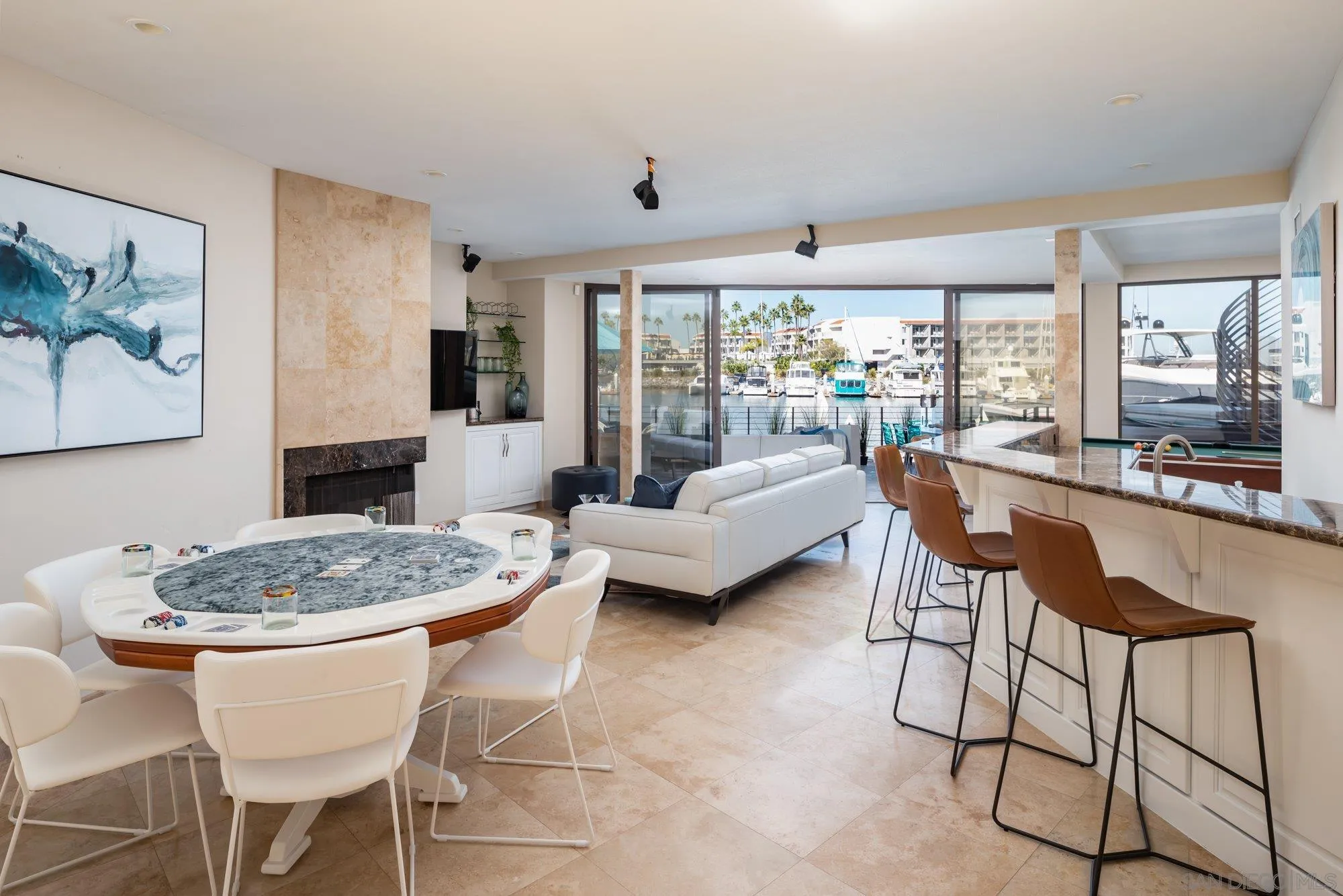 25 The Point Coronado, CA 92118 - Photo 32 of 52 a dining room with furniture a chandelier and wooden floor