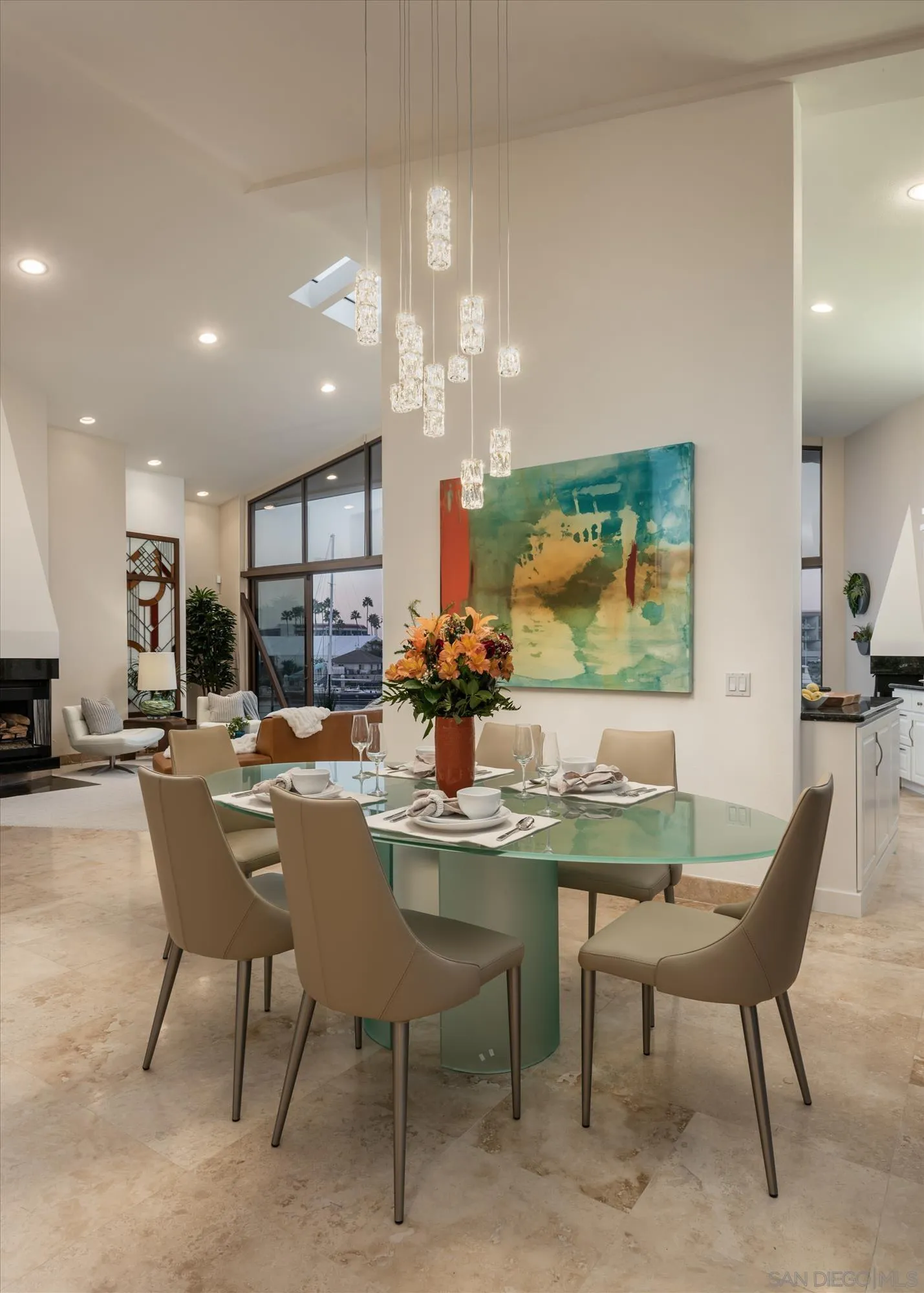 25 The Point Coronado, CA 92118 - Photo 8 of 52 a dining room with furniture a kitchen and a chandelier