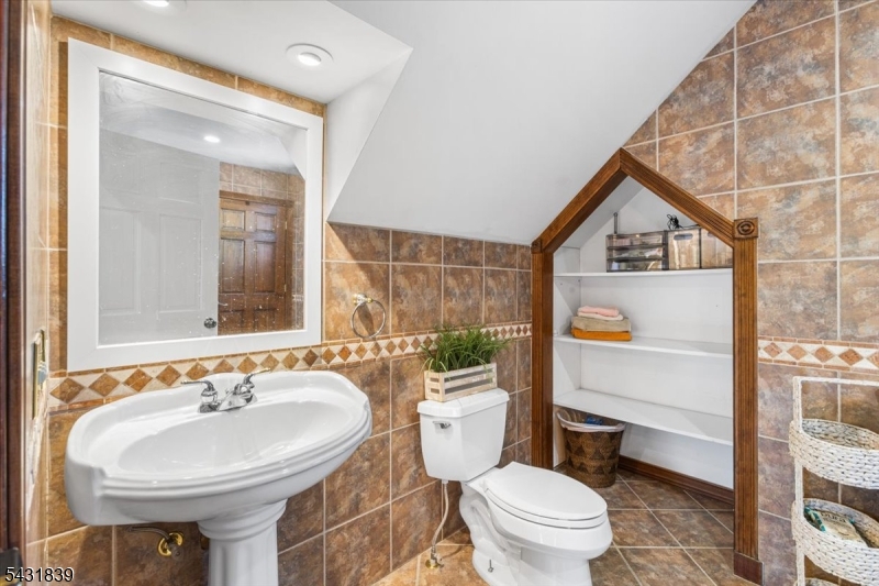 15 Spring Hunter Court Andover, NJ 07821 - Photo 36 of 49 a bathroom with a sink a toilet and a mirror