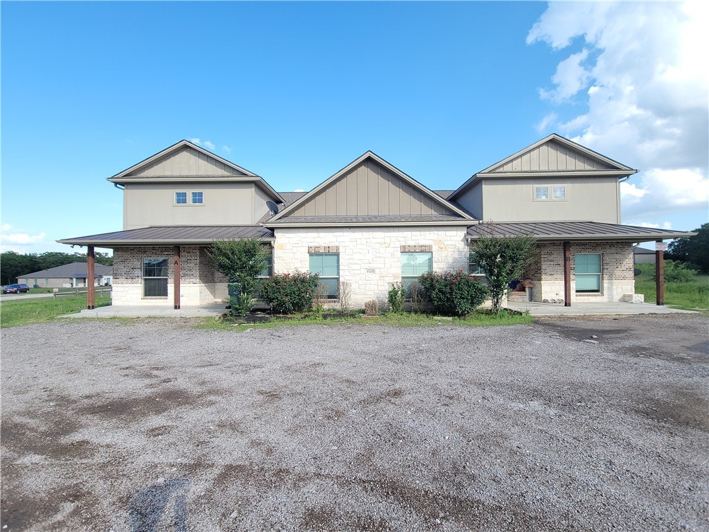 4168 Golden Eagle Drive, Unit D Bryan, TX 77808 - Photo 1 of 1 a front view of a house with a yard and garage