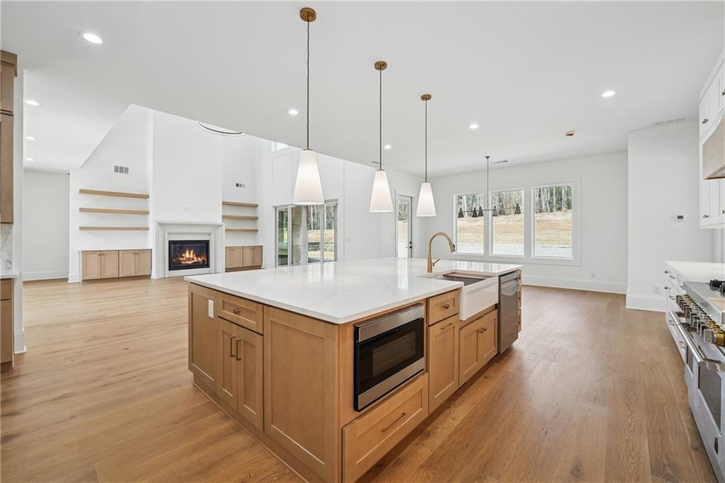3315 Bold Springs Road Dacula, GA 30019 - Photo 13 of 63 a kitchen with stainless steel appliances granite countertop a stove and a wooden floors