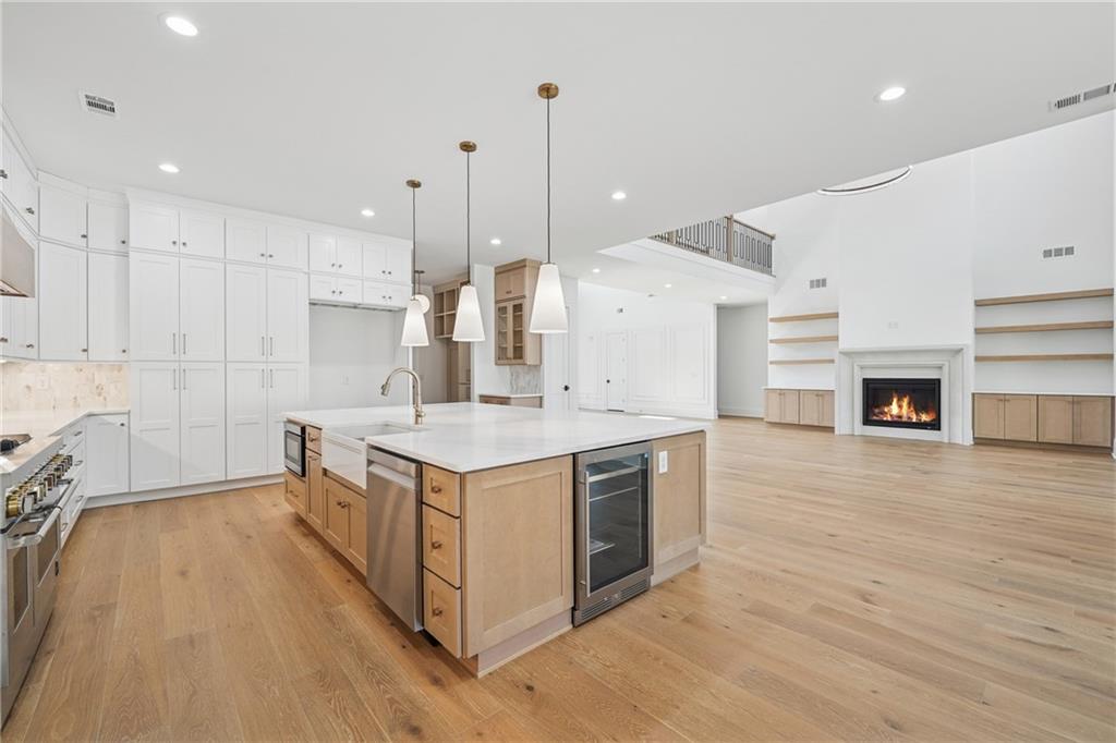 3315 Bold Springs Road Dacula, GA 30019 - Photo 14 of 63 a kitchen with stainless steel appliances granite countertop a sink a stove and a wooden floors