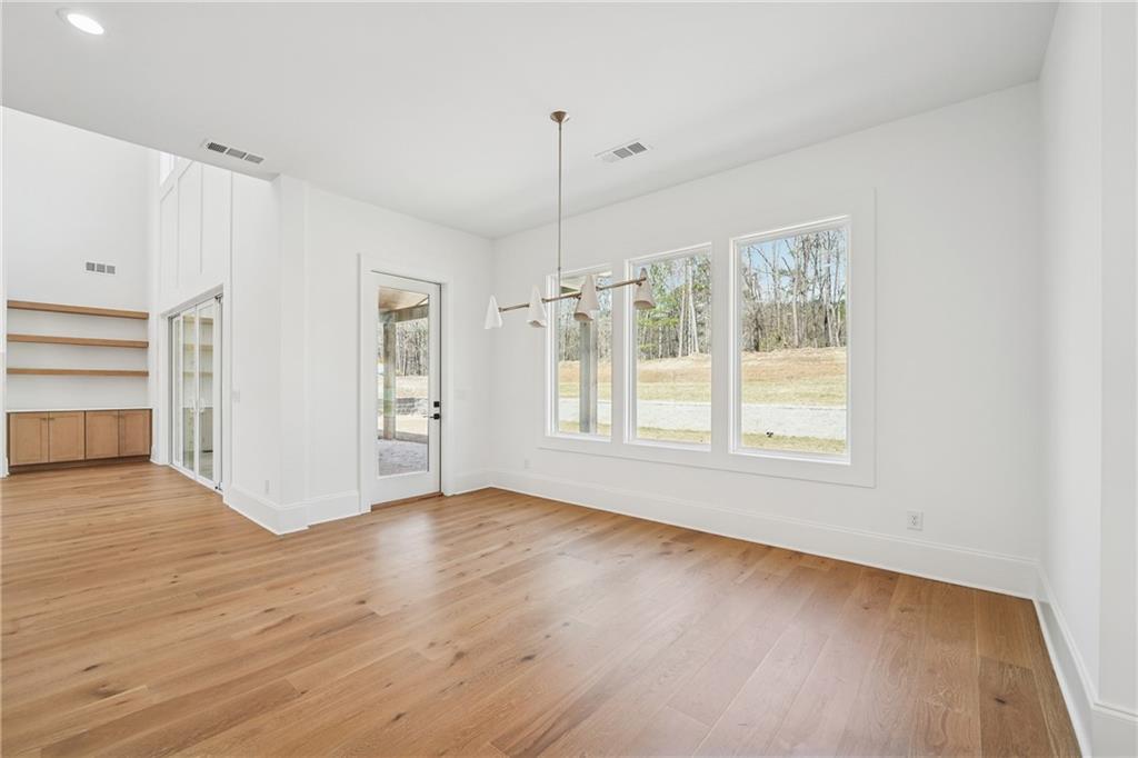 3315 Bold Springs Road Dacula, GA 30019 - Photo 15 of 63 a view of an empty room with a window and wooden floor