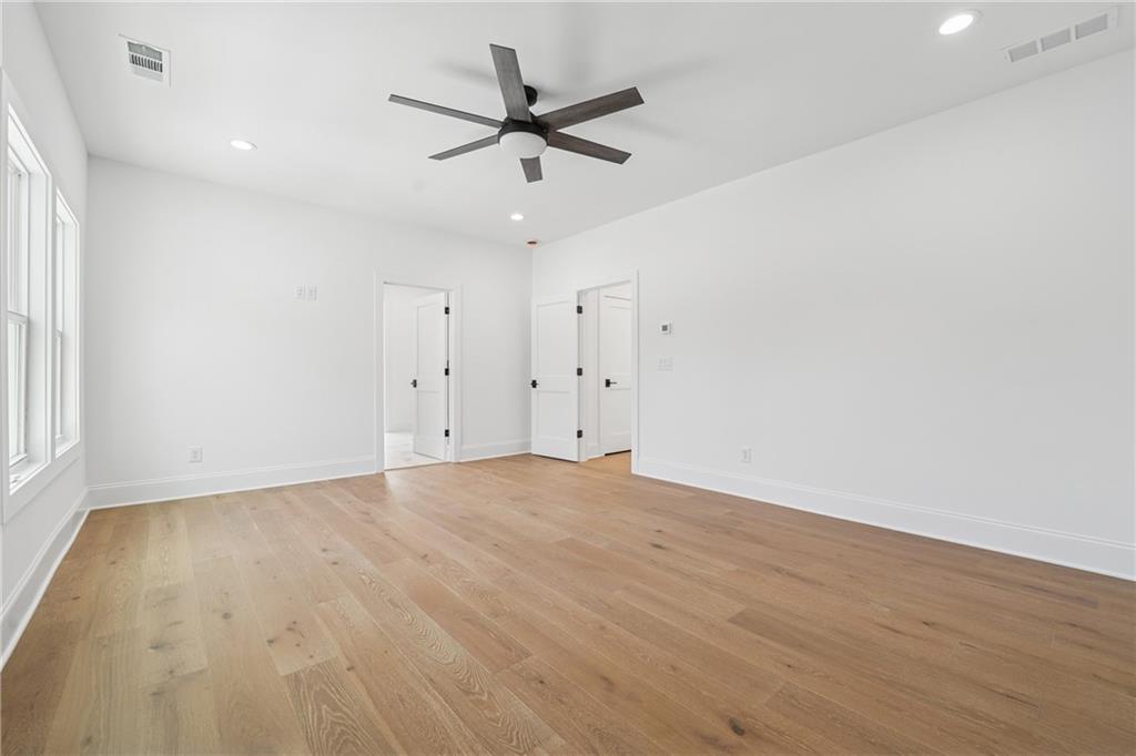 3315 Bold Springs Road Dacula, GA 30019 - Photo 27 of 63 an empty room with a ceiling fan and wooden floor