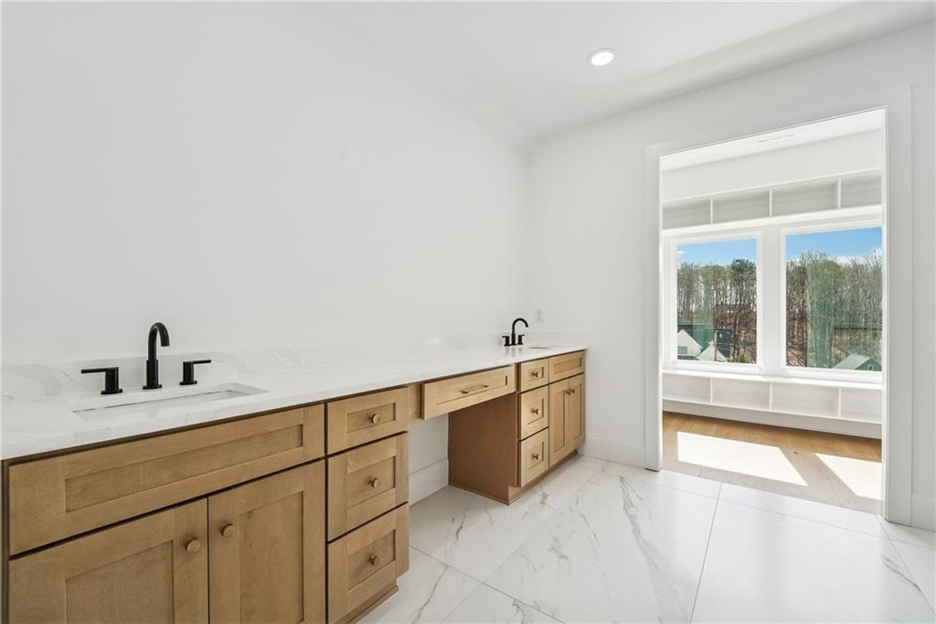 3315 Bold Springs Road Dacula, GA 30019 - Photo 28 of 63 a spacious bathroom with a granite countertop sink mirror and bathtub