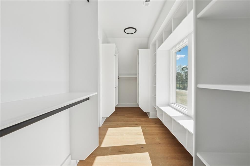 3315 Bold Springs Road Dacula, GA 30019 - Photo 30 of 63 a view of a hallway with wooden floor and staircase