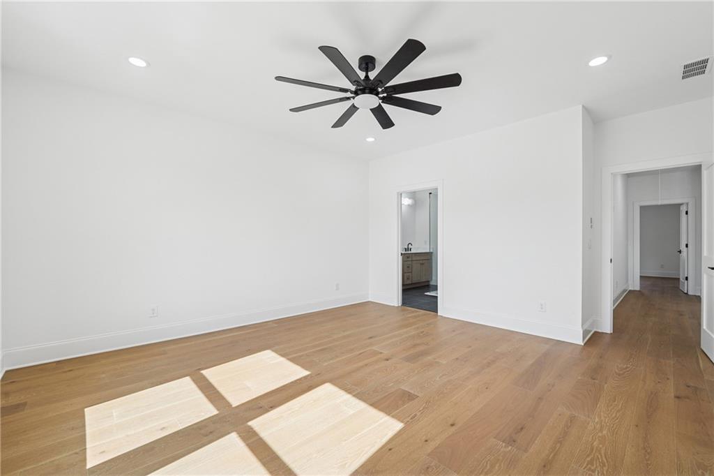 3315 Bold Springs Road Dacula, GA 30019 - Photo 32 of 63 a view of a room with a ceiling fan and wooden floor
