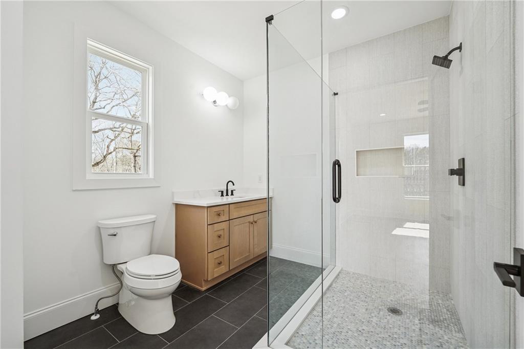 3315 Bold Springs Road Dacula, GA 30019 - Photo 33 of 63 a bathroom with a toilet sink and shower