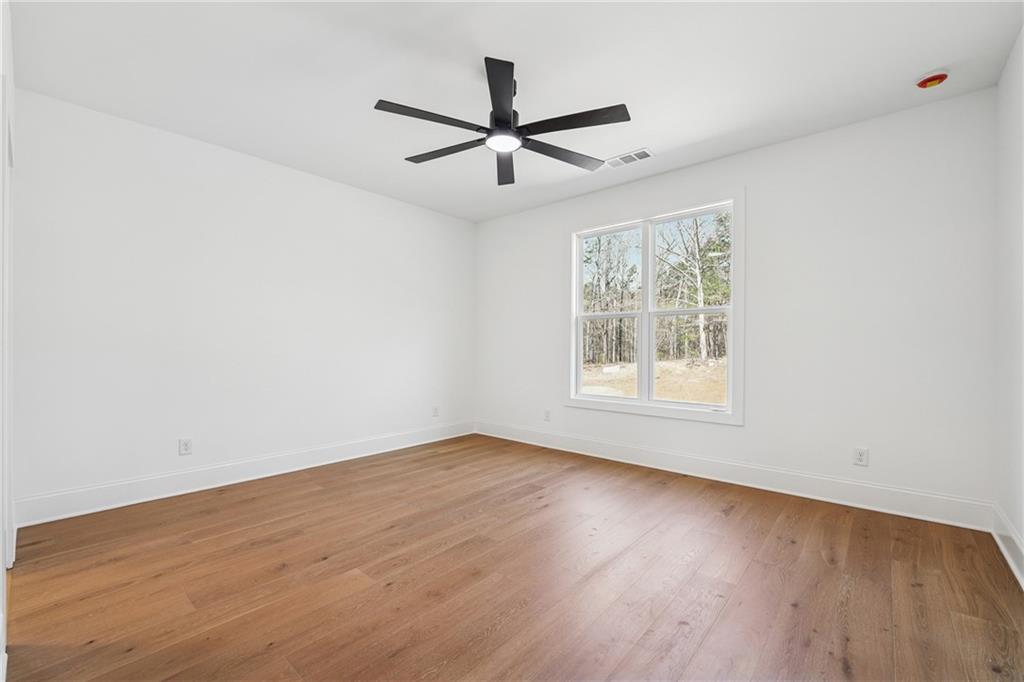3315 Bold Springs Road Dacula, GA 30019 - Photo 36 of 63 wooden floor in an empty room with a window