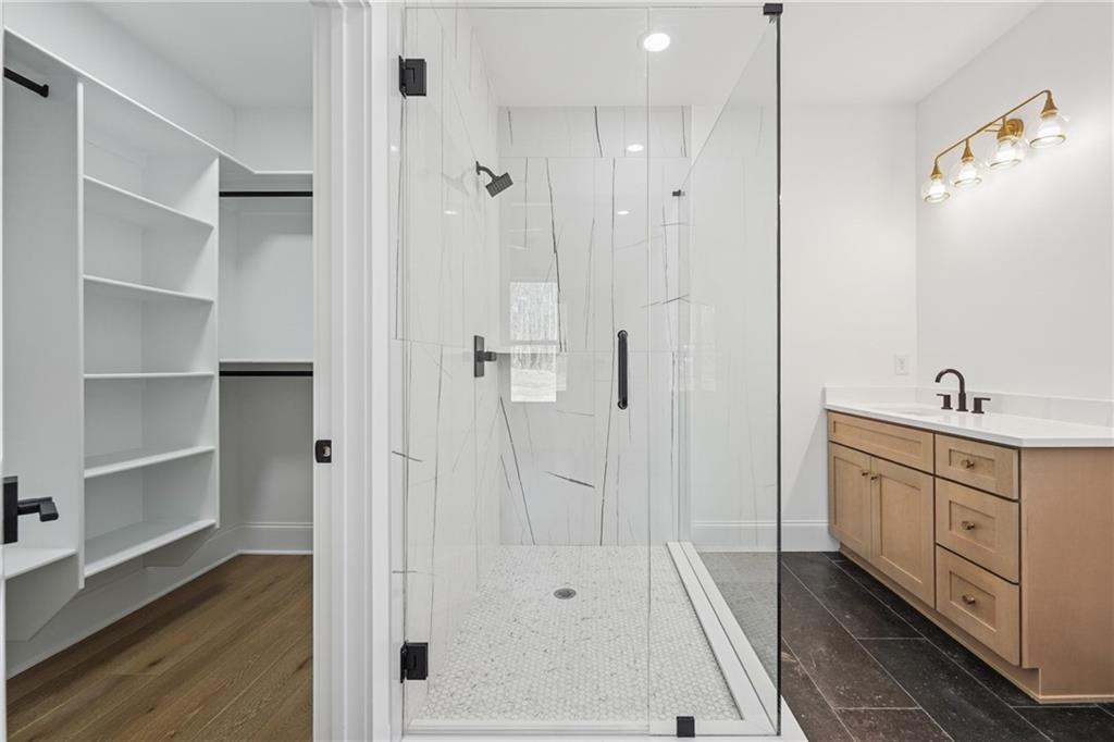 3315 Bold Springs Road Dacula, GA 30019 - Photo 38 of 63 a spacious bathroom with a double vanity sink a shower and a mirror