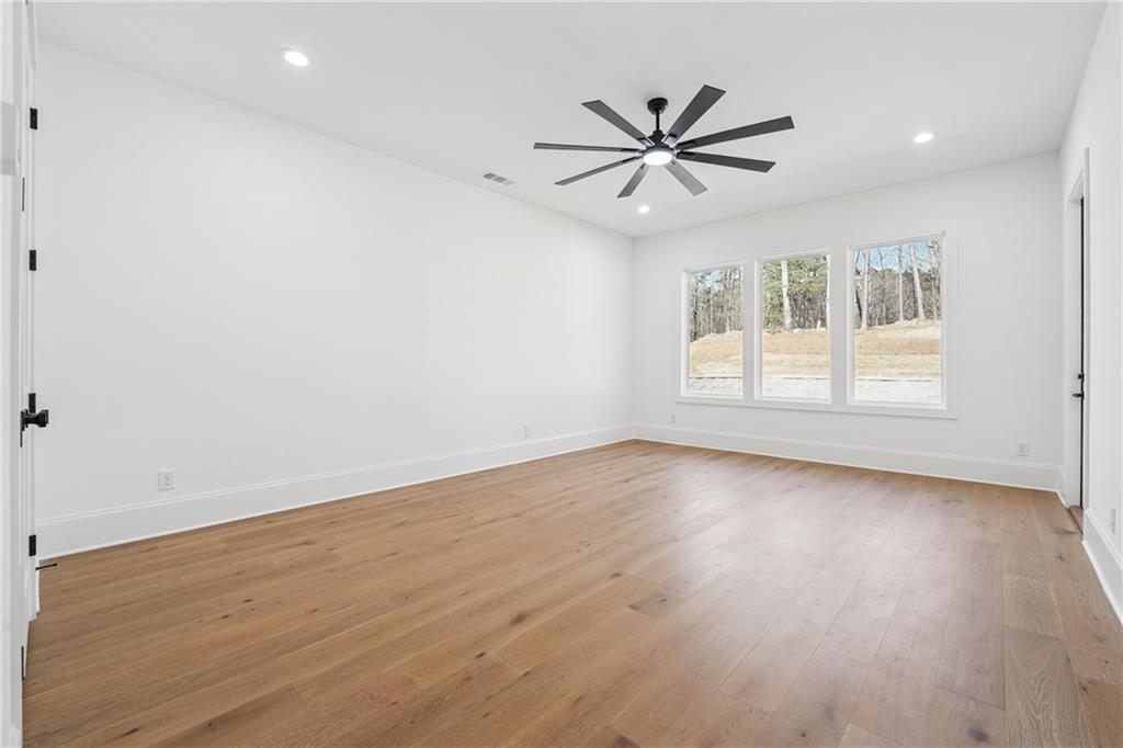 3315 Bold Springs Road Dacula, GA 30019 - Photo 40 of 63 an empty room with wooden floor and windows