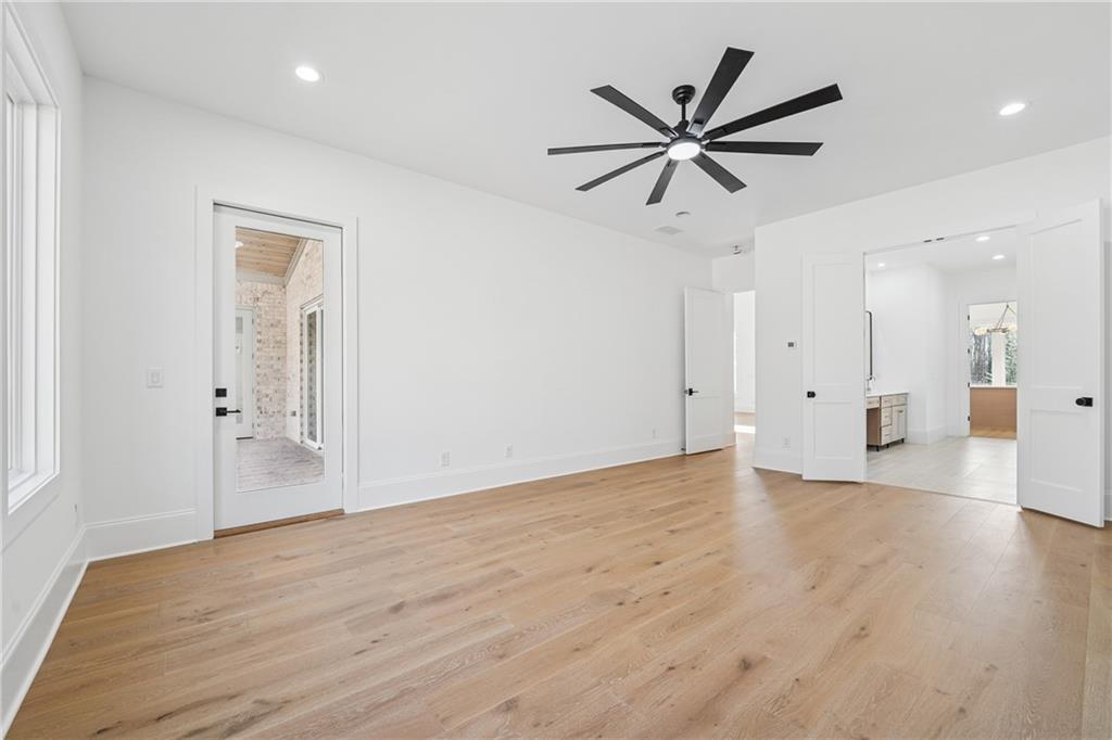 3315 Bold Springs Road Dacula, GA 30019 - Photo 41 of 63 a view of an empty room with wooden floor and a ceiling fan