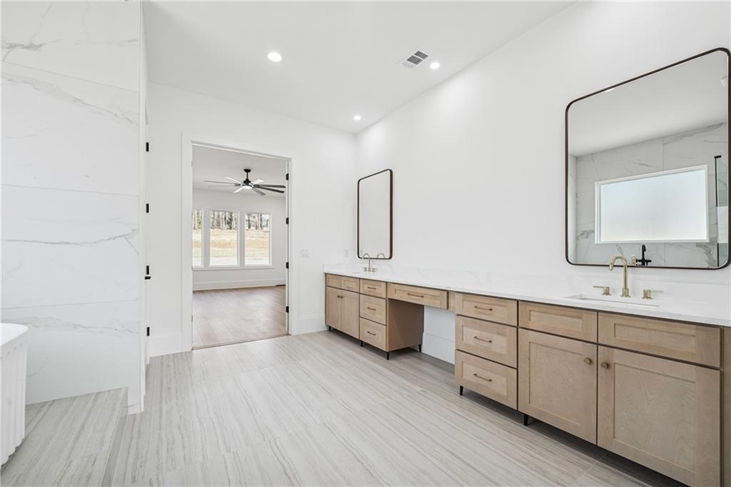 3315 Bold Springs Road Dacula, GA 30019 - Photo 45 of 63 a spacious bathroom with a double vanity sink and a mirror