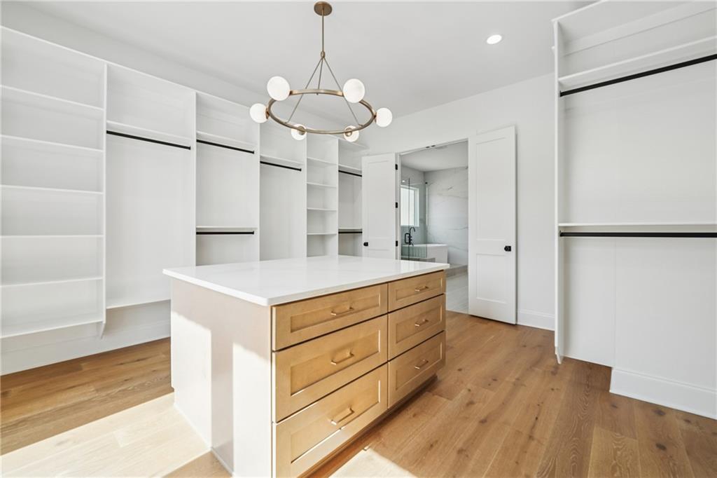 3315 Bold Springs Road Dacula, GA 30019 - Photo 48 of 63 a kitchen with stainless steel appliances a stove a refrigerator and a wooden floor